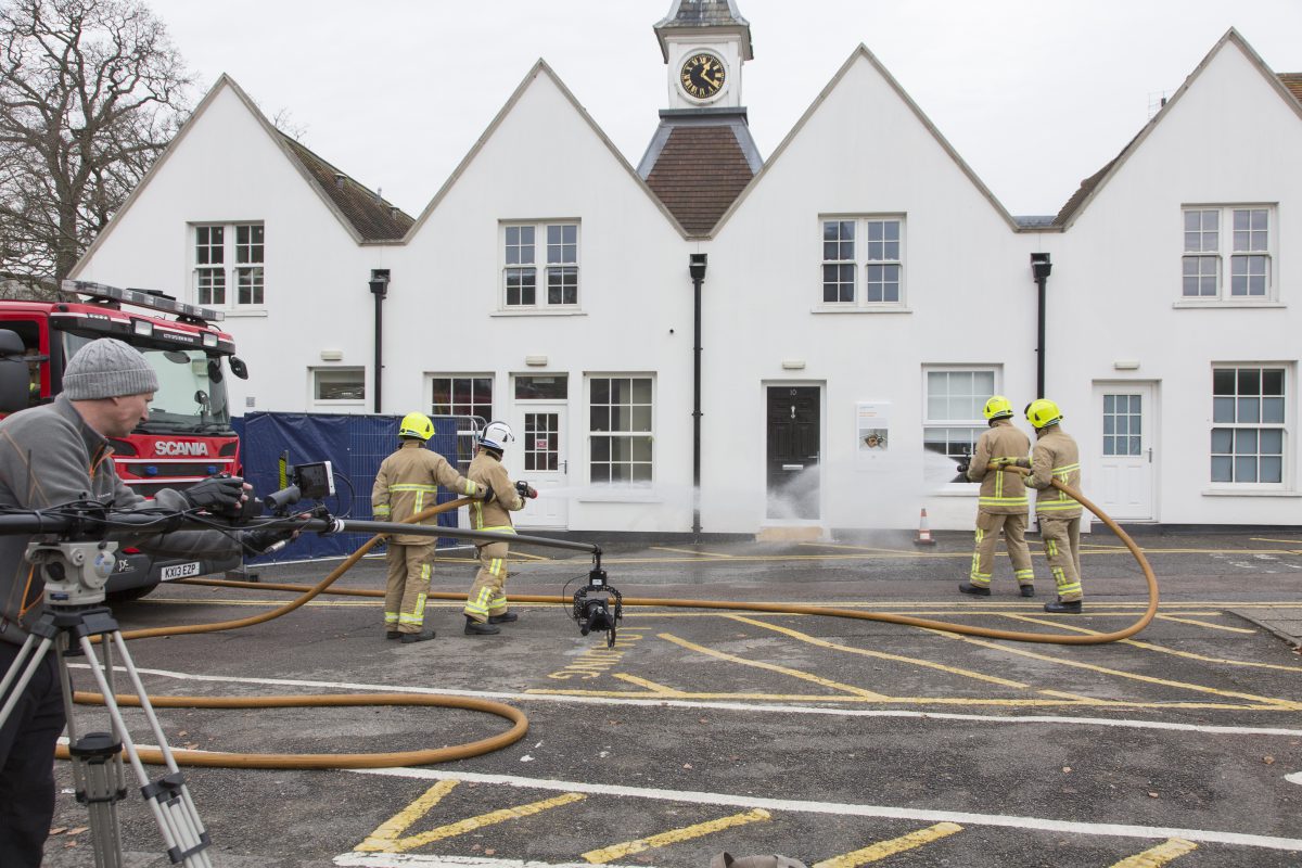 Firemen testing the flood house with giant hoses